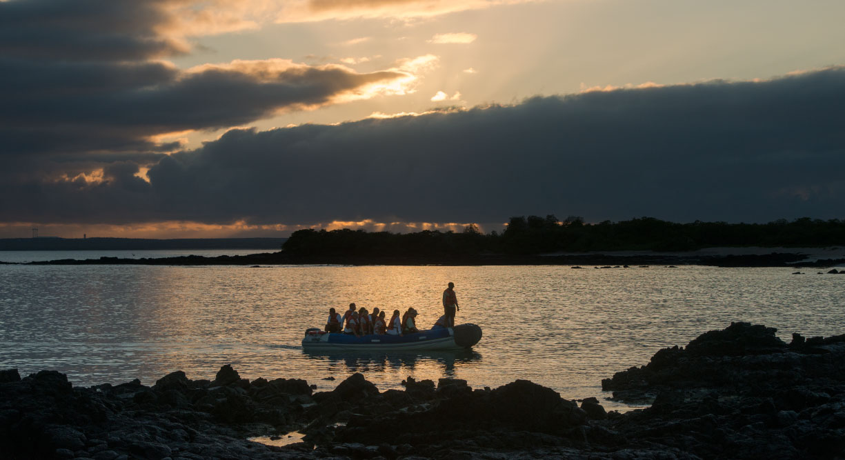 Bachas Beach - Santa Cruz in the Galapagos Islands with tourist in panga