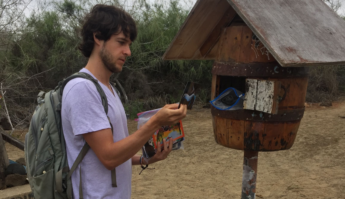 Post Office - Floreana Island in the Galapagos, tourist showing letters