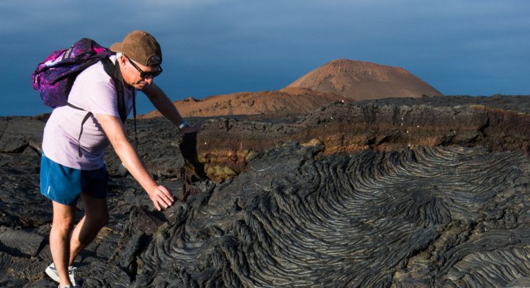 Sullivan bay in Santiago Island, solid volcanic lava with tourist