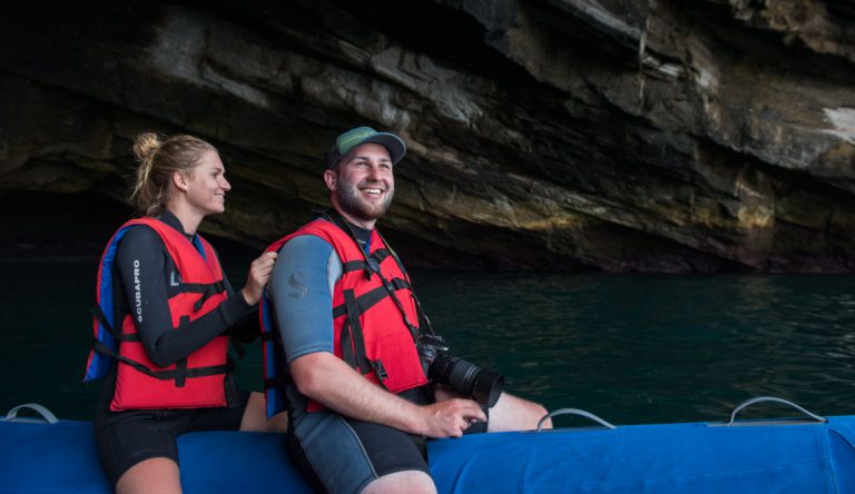 Vicente Roca Point in Isabella Island, tourists playing on the sea